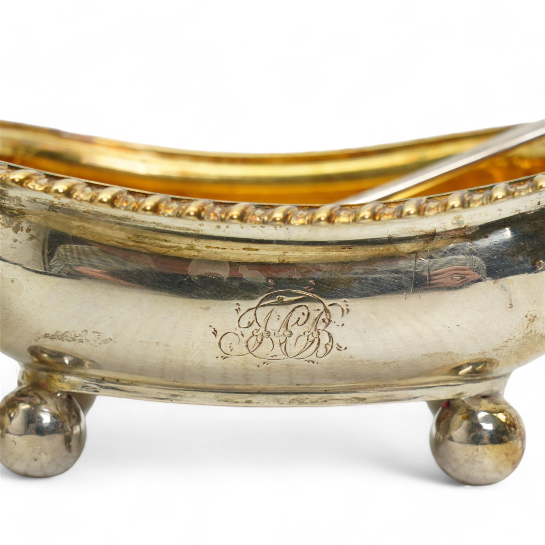 Pair of George III silver salts of elongated oval design with gilded interior and gadrooned border engraved with a monogram, raised on ball feet each 8.5cm x 6cm London 1820 Maker Rebecca Emes and Edward Barnard I together with a pair of later salt spoons