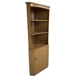 Ercol - mid-20th century '743C'  light elm corner cabinet, fitted with two open shelves over a single cupboard