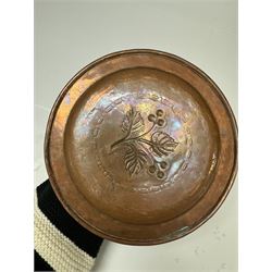 Middle eastern copper bucket, with chased and embossed band of animal decoration, together with a copper jardinière embossed with floral panels, copper plate with embossed leaf motif and two brass helmet shaped coal scuttles, bucket H26cm