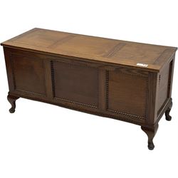 Early 20th century oak blanket chest, rectangular hinged lid with decorative panelling, the front and sides adorned with beaded panels, on cabriole feet