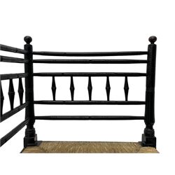 In the manner of William Morris - Arts & Crafts period corner chair, swell turned horizontal rails with balustrade back, rush seat on ring turned supports, black paint finish 