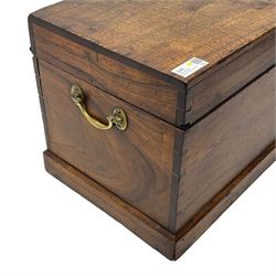 19th century teak blanket chest, hinged lid over plain front, fitted with brass carrying handles on plinth base 