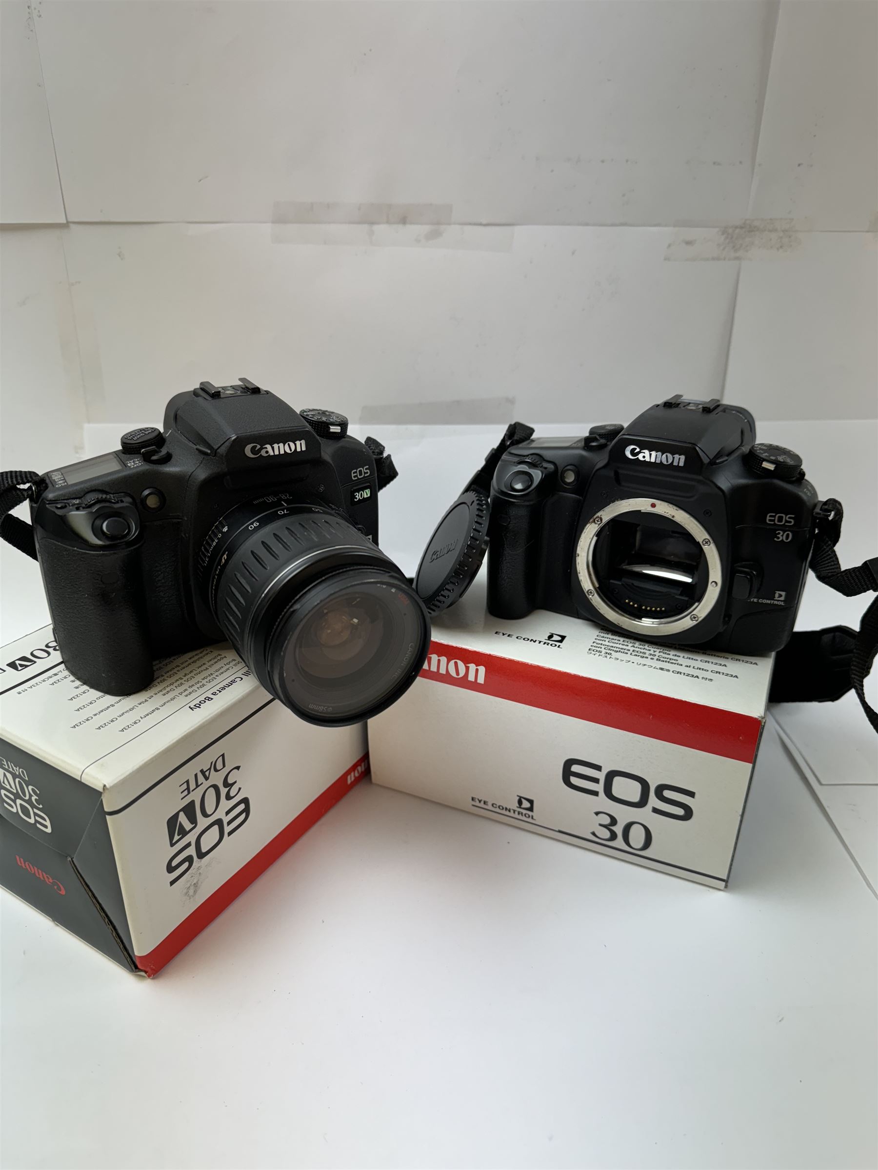 Canon EOS 30V SLR camera body serial no. (21)95000615, with a Canon EF 28-90mm 1:4-5.6 USM zoom lens serial, together with a Canon EOS 30 SLR camera body serial no. (21)71001811, both with original boxes and a Lowepro carry case