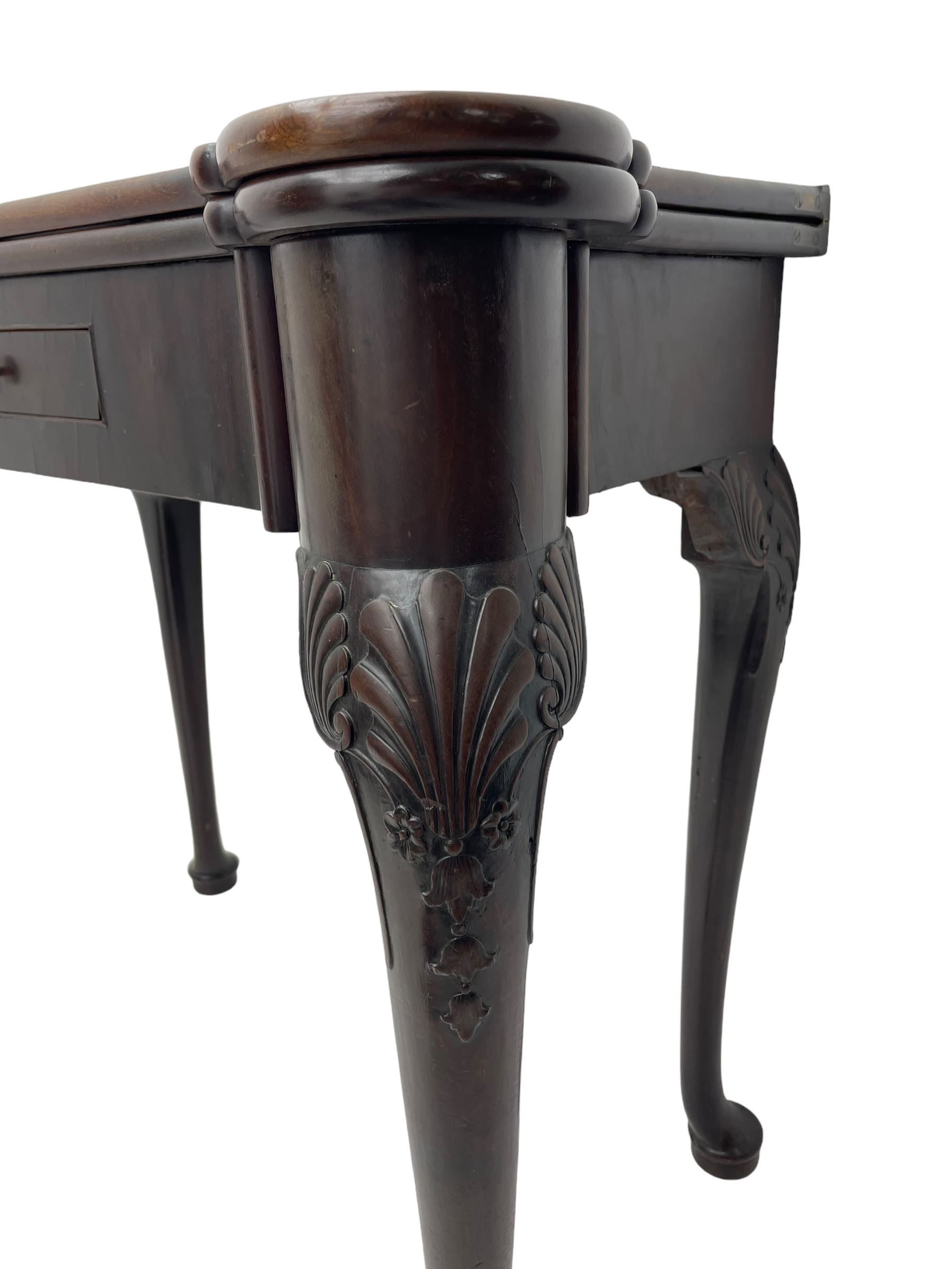 Late 18th century Irish mahogany tea table, rectangular form with projecting stepped rounded corners, fold-over action top over single frieze drawer within cock-beaded surround, on shell and bellflower carved cabriole supports, single gate-leg action base 