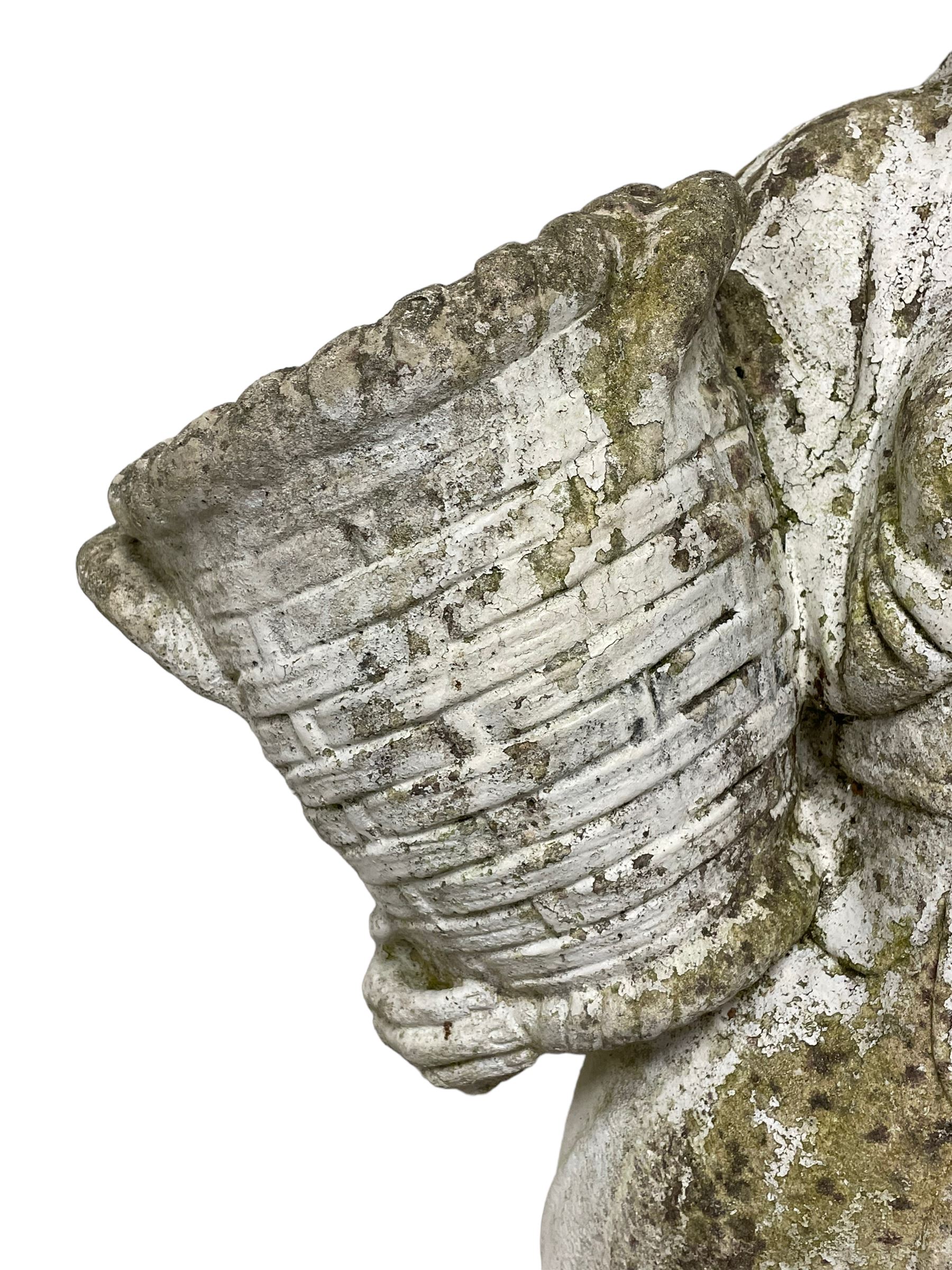 Weathered and painted cast stone garden statue, in the form of an Italian maiden carrying baskets with gathered flora and berries, on a shaped ovoid base