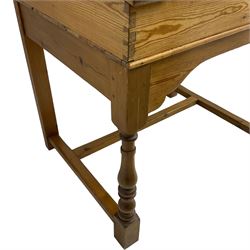 Early 20th century pitch pine clerk’s desk, stripped mahogany sloped hinged top, raised on turned supports