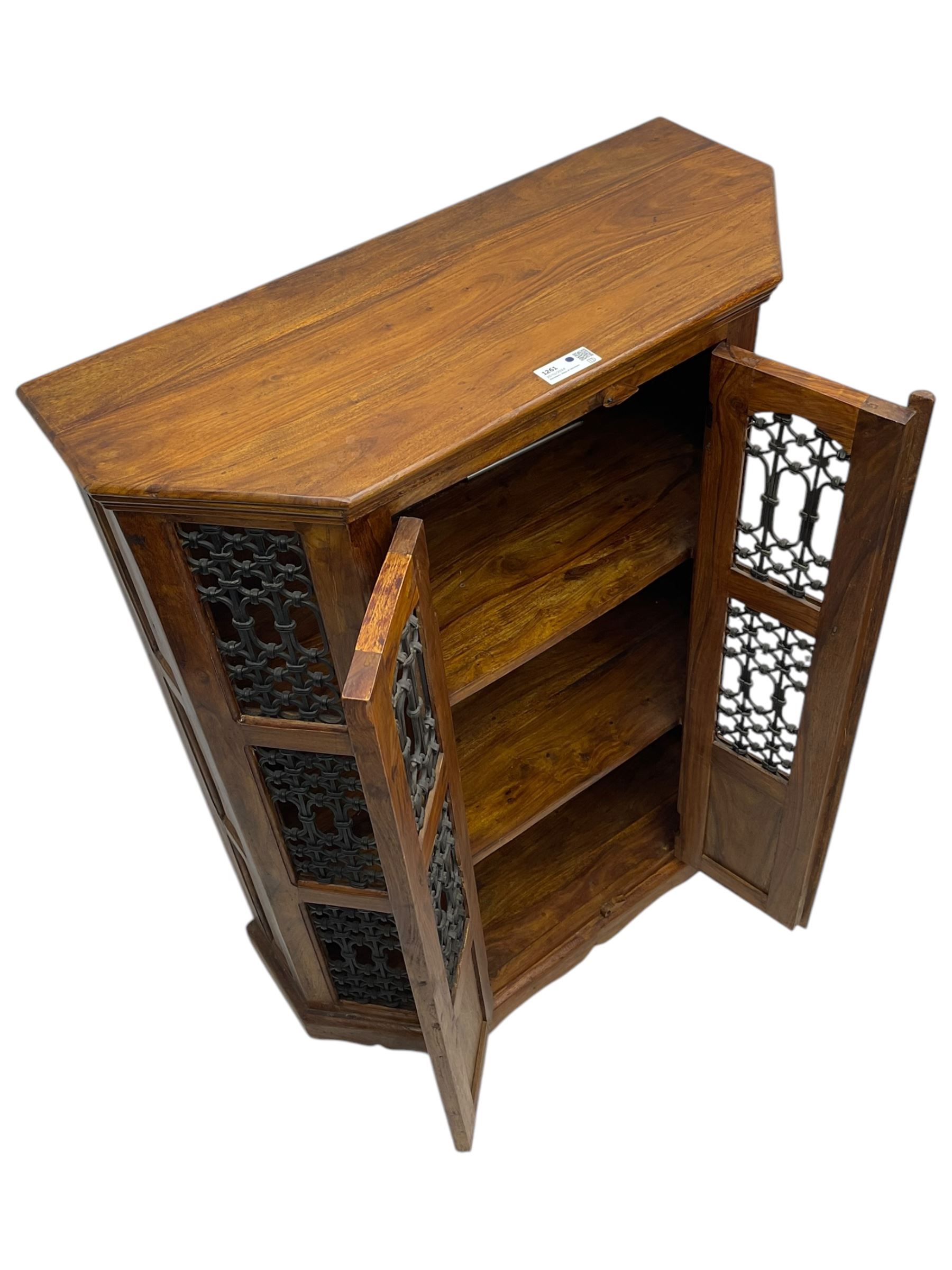 Hardwood and wrought iron cabinet, enclosed by two doors, on plinth base 