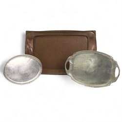 Large Arts & Crafts rectangular copper tray, with lightly hammered decoration and a shaped border, L70.5cm, Art Nouveau oval pewter two-handled tray by Hutton, Sheffield, L49cm over handles, and a stainless steel oval tray by Hugh Wallis, L36cm (3)