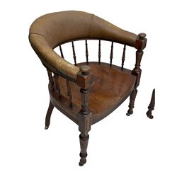 Pair of late Victorian walnut tub-shaped elbow chairs, the cushioned cresting rail upholstered in leather on spindle turned supports, dished saddle seat on turned supports