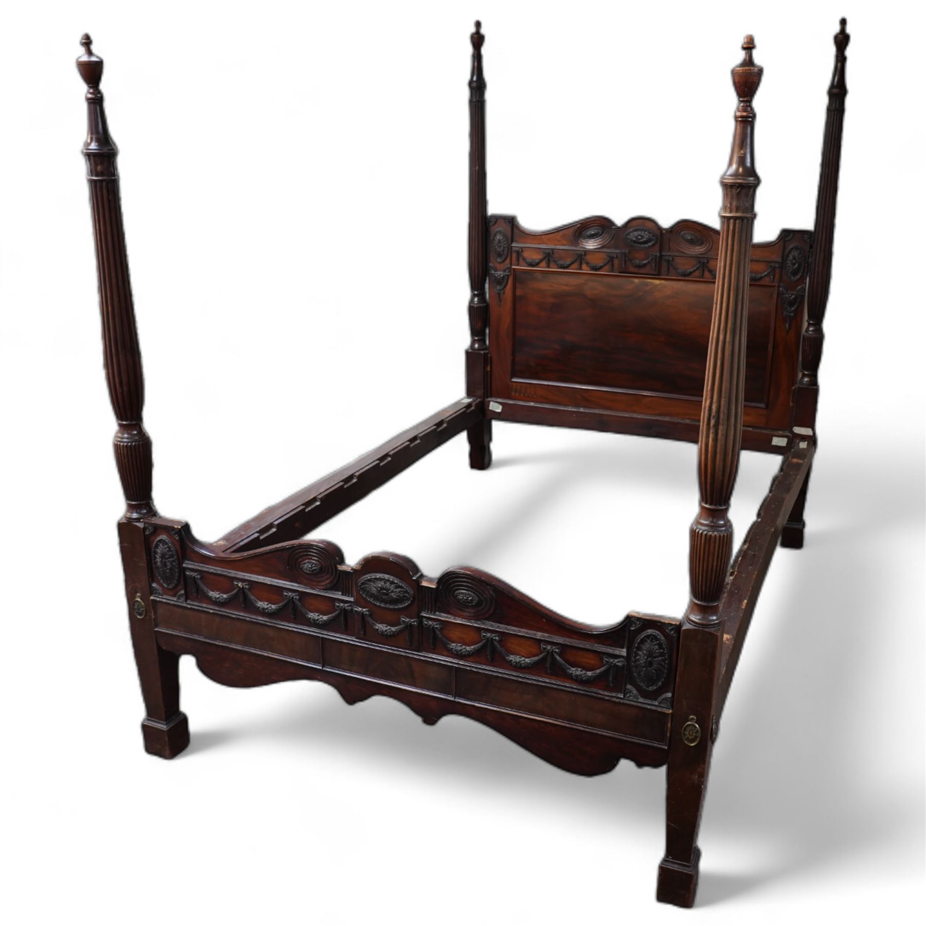 19th century and later Hepplewhite design mahogany four poster double bed, urn finials atop reeded and turned pilasters, head and footboard decorated with carved and moulded floral festoons and acanthus rosettes, shaped apron over shaped supports and square feet