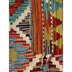 Chobi Kilim ground runner, the field decorated with a geometric pattern of coloured diamonds and triangles, each containing stylised motifs, the shorter ends enclosed by a plain border, and the longer sides with a multicoloured border

