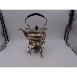 Early 20th century silver spirit kettle and burner, of oval form, with oblique gadrooned rim, engraved crest and ebonised handle and finial, the stand upon three scrolling pad feet, hallmarked Goldsmiths Silversmiths Company, London 1913, total H31cm