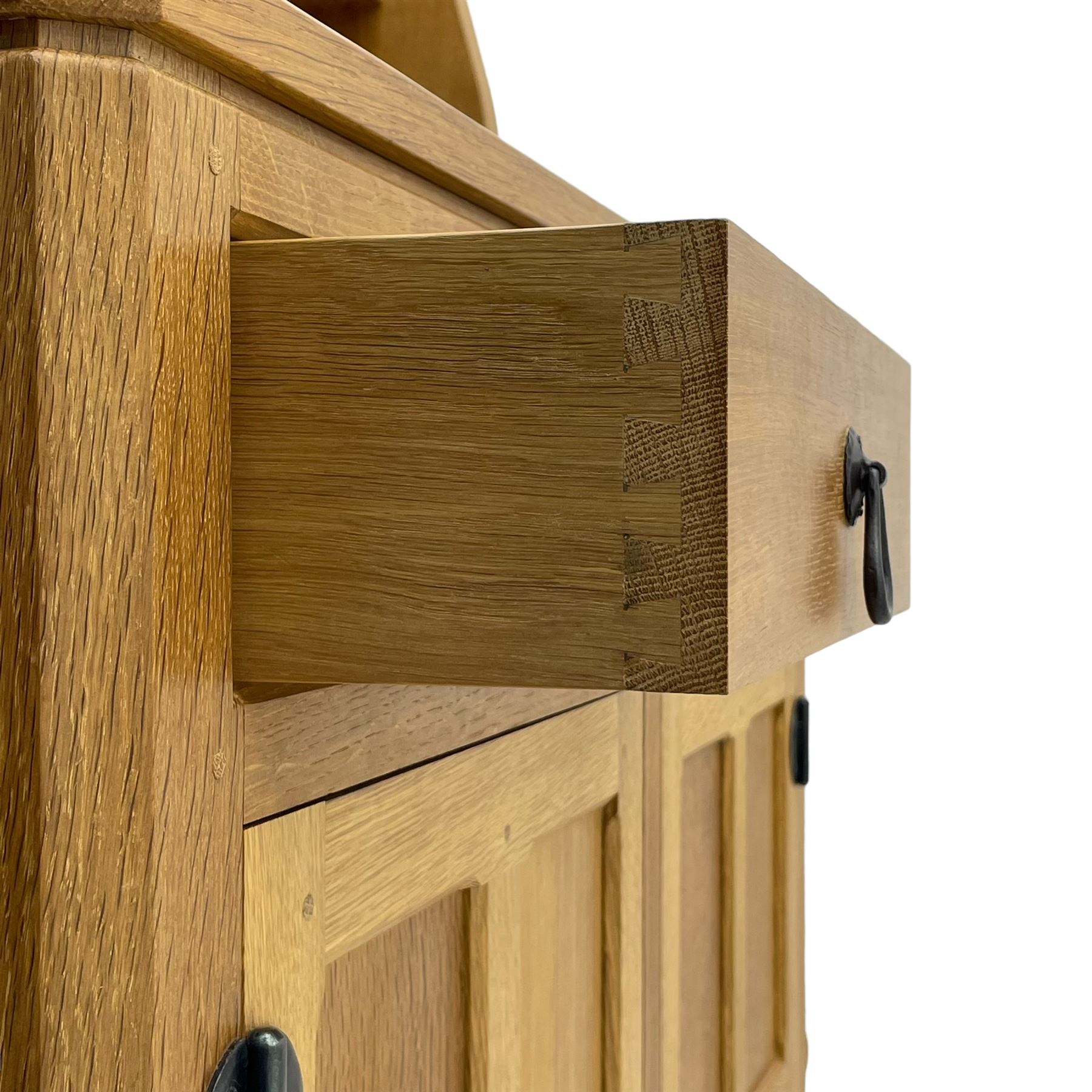 Mouseman - oak dresser, penny moulded cresting rail over two shelves supported by shaped ends, canted rectangular adzed top, fitted with two drawers and panelled cupboards, with wrought iron hinges and catches, on octagonal feet, carved with mouse signature, by the workshop of Robert Thompson, Kilburn 