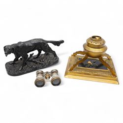 19th century gilt brass inkstand, of circular form, the hinged cover decorated with hardstone fruit and foliage upon a black ground, opening to reveal ink recess, upon four raised feet with a stepped square base, decorated with engraved foliate boarder, the black central panel with similar hardstone decoration H16cm; together with a pair of Chevalier of Paris opera glasses and a cast metal sculpture of a hunting dog (3)