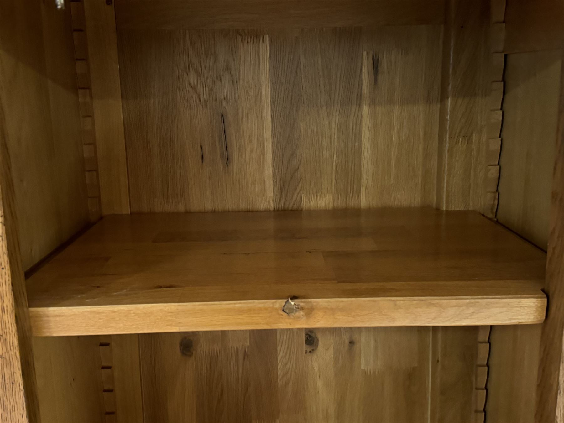 Large 20th century oak dresser, projecting cornice over open arched central section with two shelves, flanked by two panelled cupboards with two shelves, lower section with three drawers above three cupboards, on stile supports 