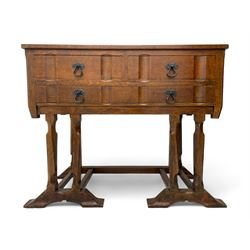 Arts & Crafts design oak chest on stand, rectangular top over two short and one long drawer, on a series of shaped and tapered supports with carved and beaded decoration, united by chamfered stretchers rails, on sledge feet 