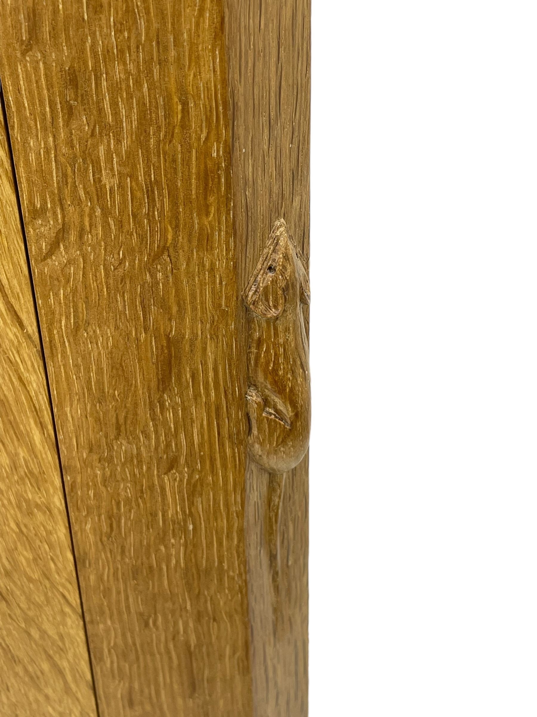 Mouseman - oak dresser, penny moulded cresting rail over two shelves supported by shaped ends, canted rectangular adzed top, fitted with two drawers and panelled cupboards, with wrought iron hinges and catches, on octagonal feet, carved with mouse signature, by the workshop of Robert Thompson, Kilburn 