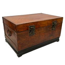 Chinese leather bound and wooden trunk, fitted with metal locks and twin carrying handles, on ebonised stand 