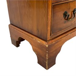 Georgian design yew wood bachelor's chest, fold-over rectangular top supported by pull-out stays, fitted with four long cock-beaded drawers, on bracket feet