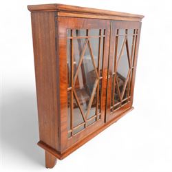 Edwardian inlaid mahogany wall-hanging cabinet, fitted with two astragal glazed doors enclosing two shelves, over shaped brackets