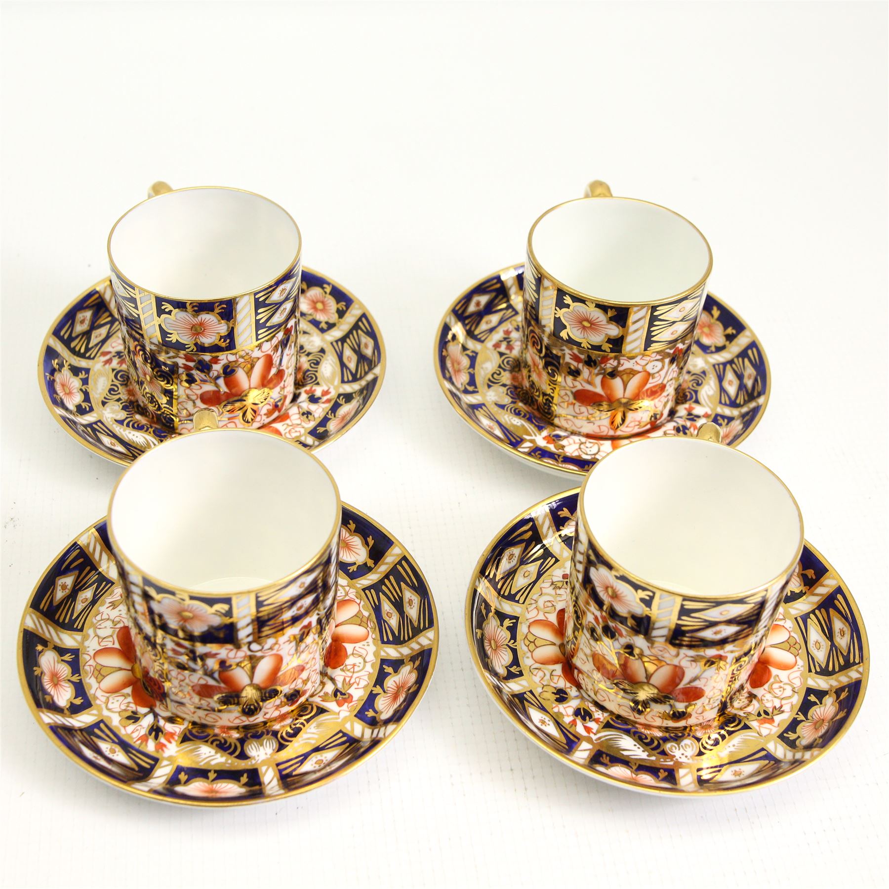 Set of four Royal Crown Derby Imari pattern coffee cans and saucers, pattern 2451and a set of four matching plates D15cm