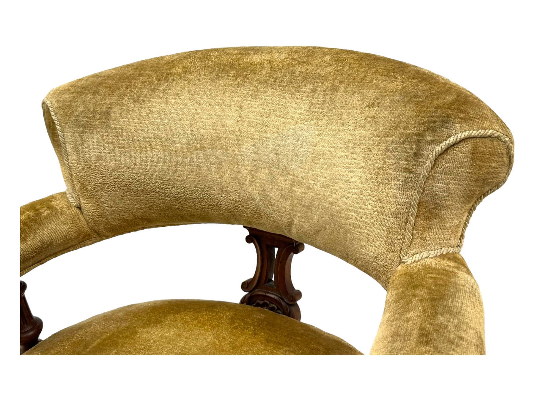 Victorian pair of mahogany armchairs, upholstered in gold velvet fabric, each with curved back, pierced splat and scroll arms, one with rounded seat and the other square, on turned front supports with castors