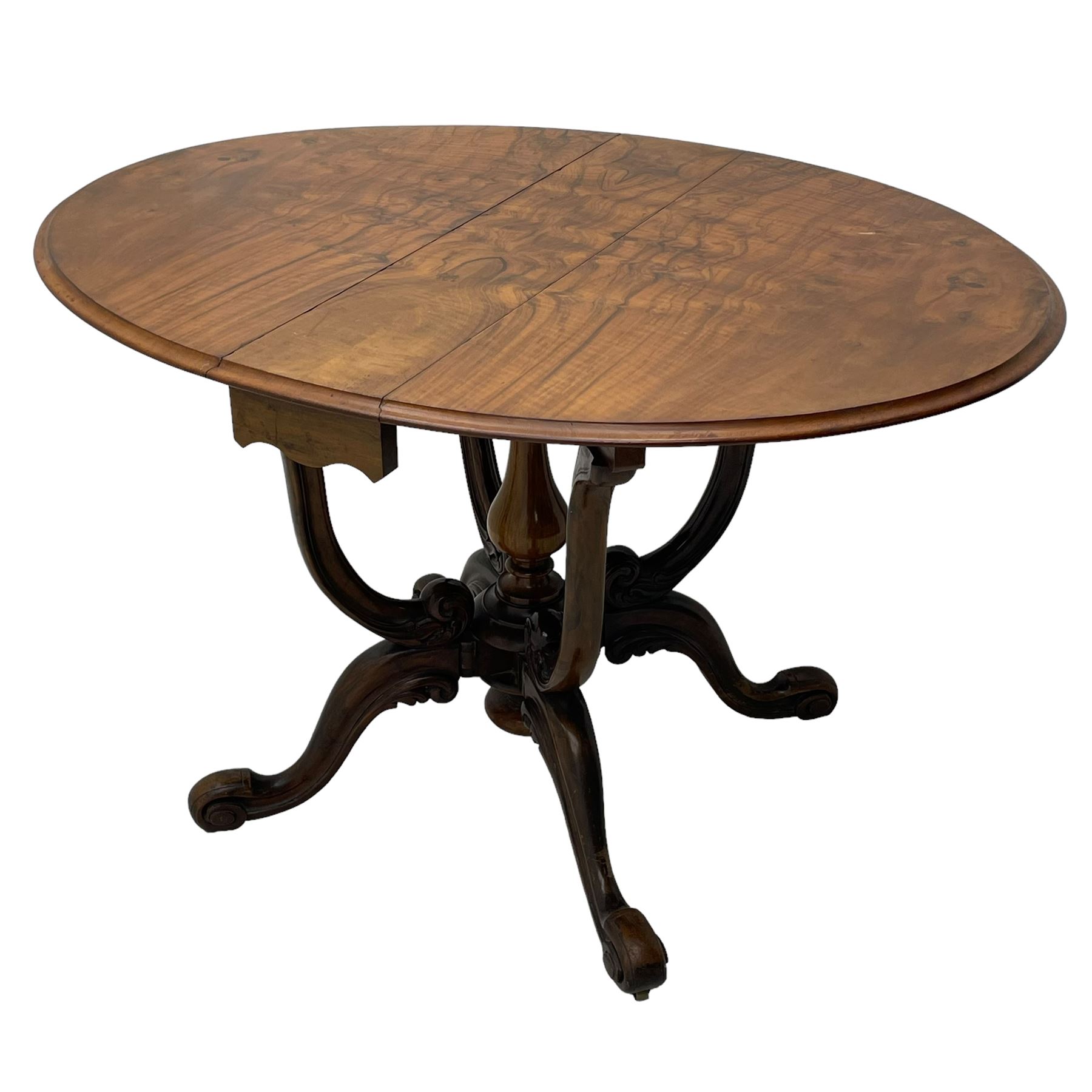 Unusual Victorian figured walnut drop-leaf Sutherland table, moulded drop-leaf oval top, central turned baluster column with quadruple moulded S-scroll supports carved with acanthus leaves, four out-splayed supports with scroll carved terminals, double gate-leg action base, on castors