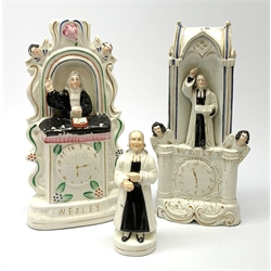 A Staffordshire pulpit group, modelled as John Wesley, H28.5cm, together with another similar Staffordshire example, and a small Staffordshire figure of John Wesley, H14.5cm. 