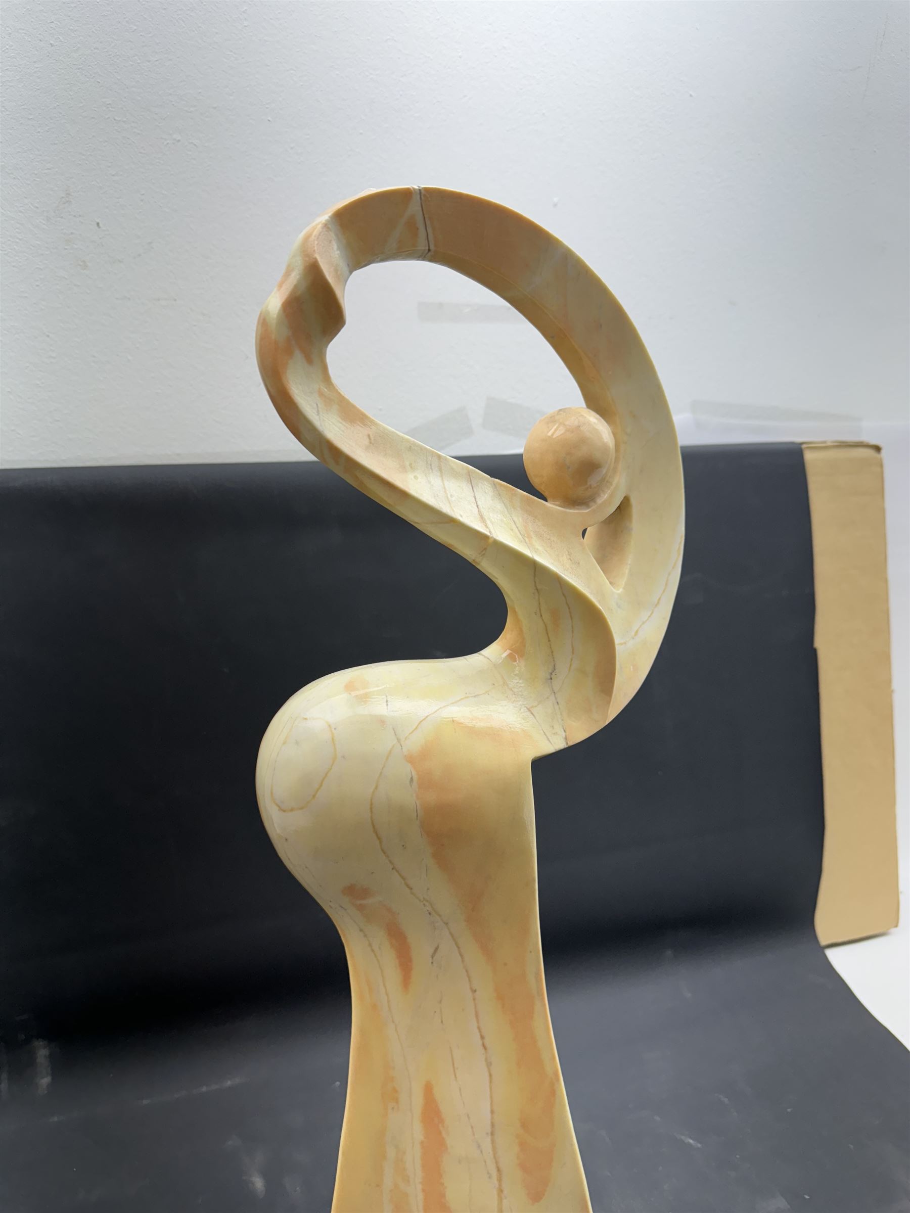 Abstract marble sculpture modelled as a dancer, upon a rectangular base, H58cm