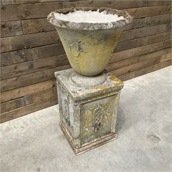 Cast stone vase shaped urn, mounted on square plinth