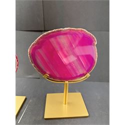 Pair of pink agate slices, polished with rough edges, raised upon gilt metal stands, H20cm