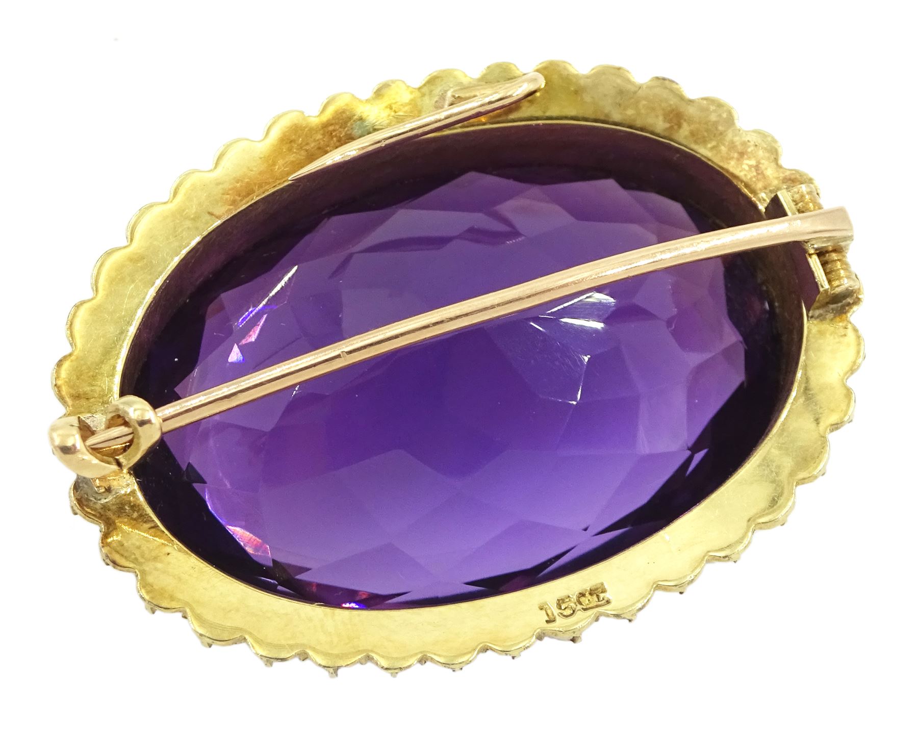 Early 20th century gold large oval cut amethyst and seed pearl brooch, stamped 15ct