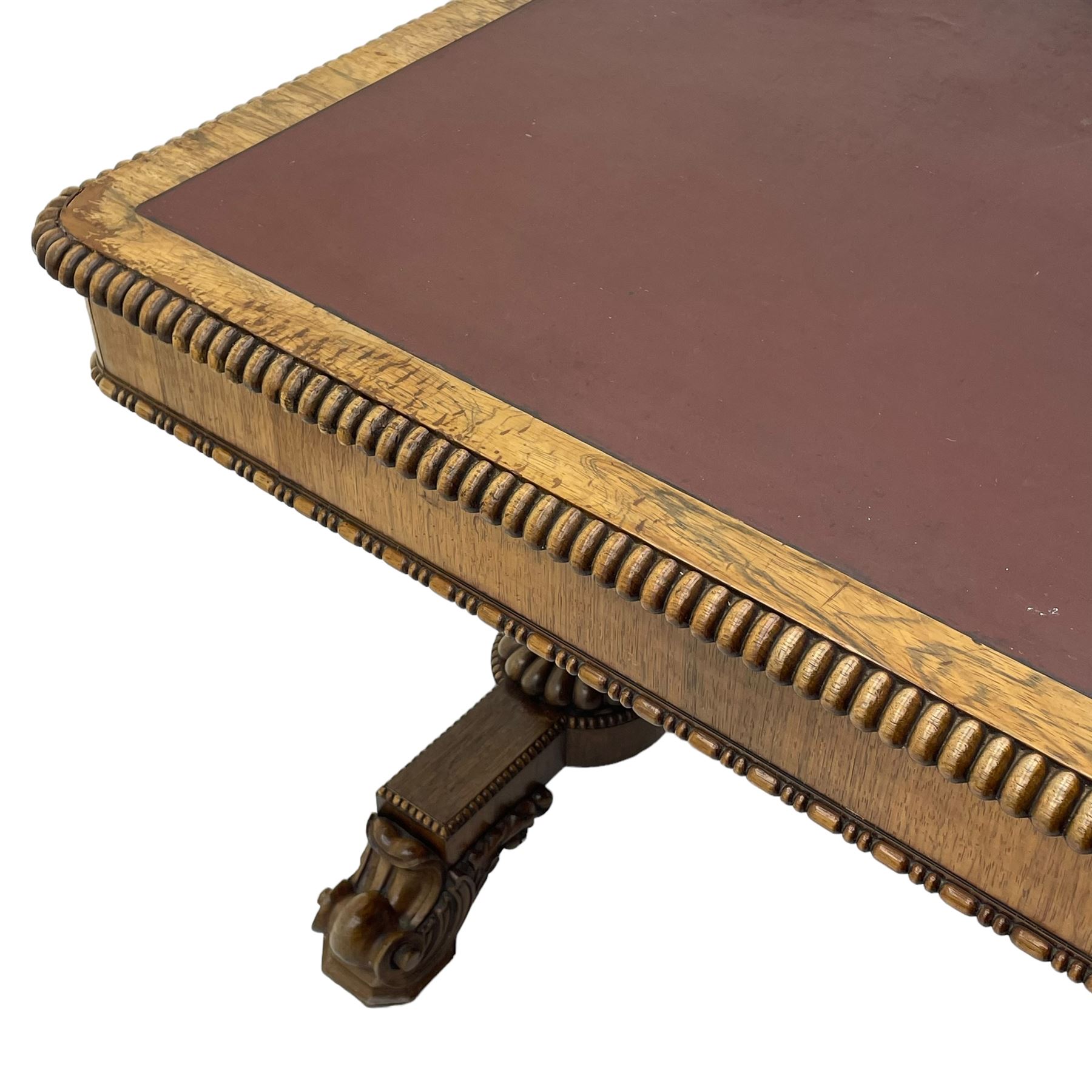 Early 19th century Regency rosewood writing table, rectangular top with inset leather writing surface and gadroon moulded edge, fitted with single frieze drawer, on twin turned pillar supports with lobe carved balusters, on platforms with beaded edge, acanthus scroll carved feet