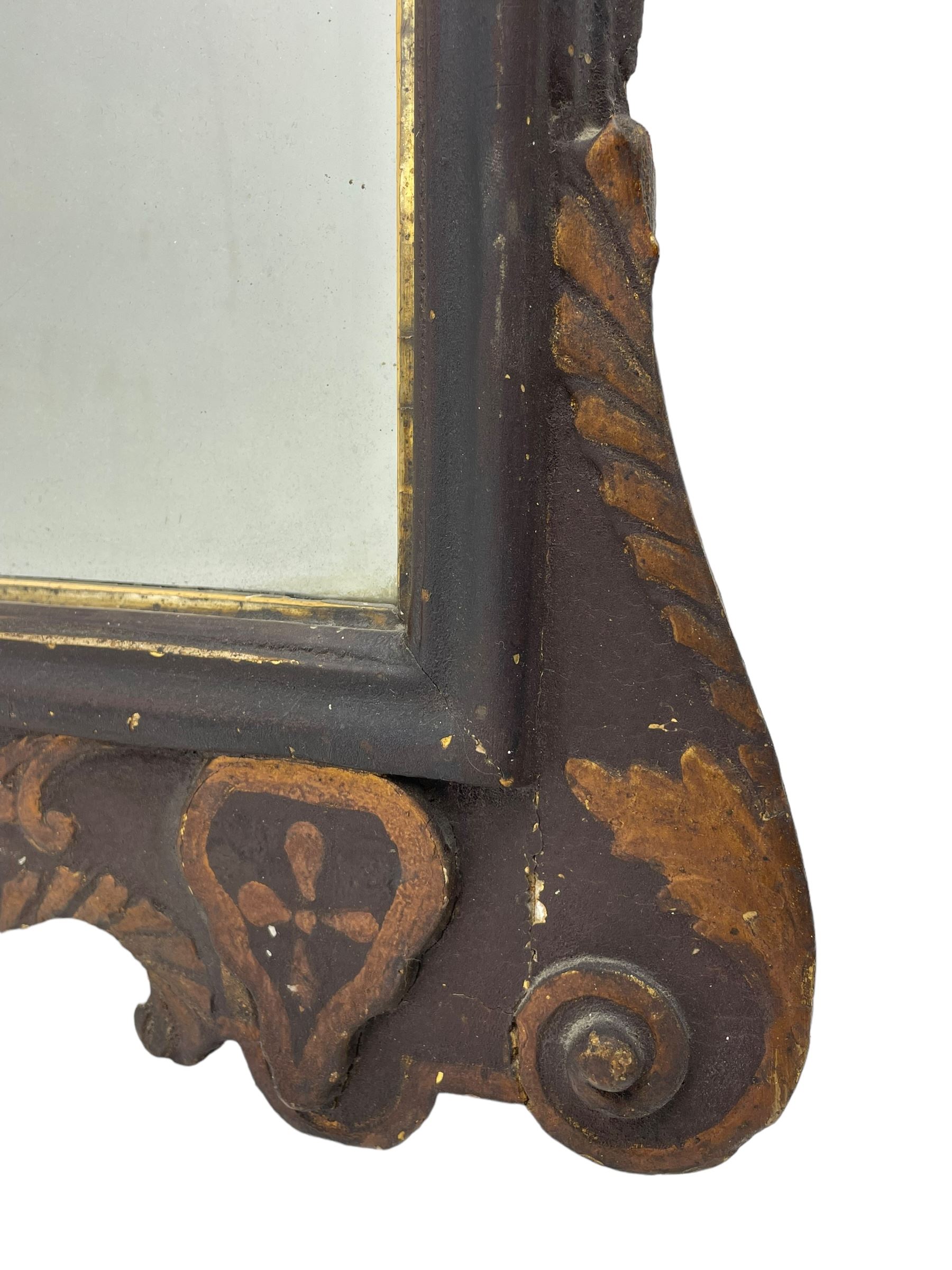 18th century black lacquered and gilt wall mirror, broken arch pediment with central cartouche decorated with curled leaves and foliate motifs, scrolled acanthus leaf eared brackets, bevelled mirror plate within gilt slip and moulded outer frame, lower shell motif surrounded by curled acanthus leaves and shield motifs 