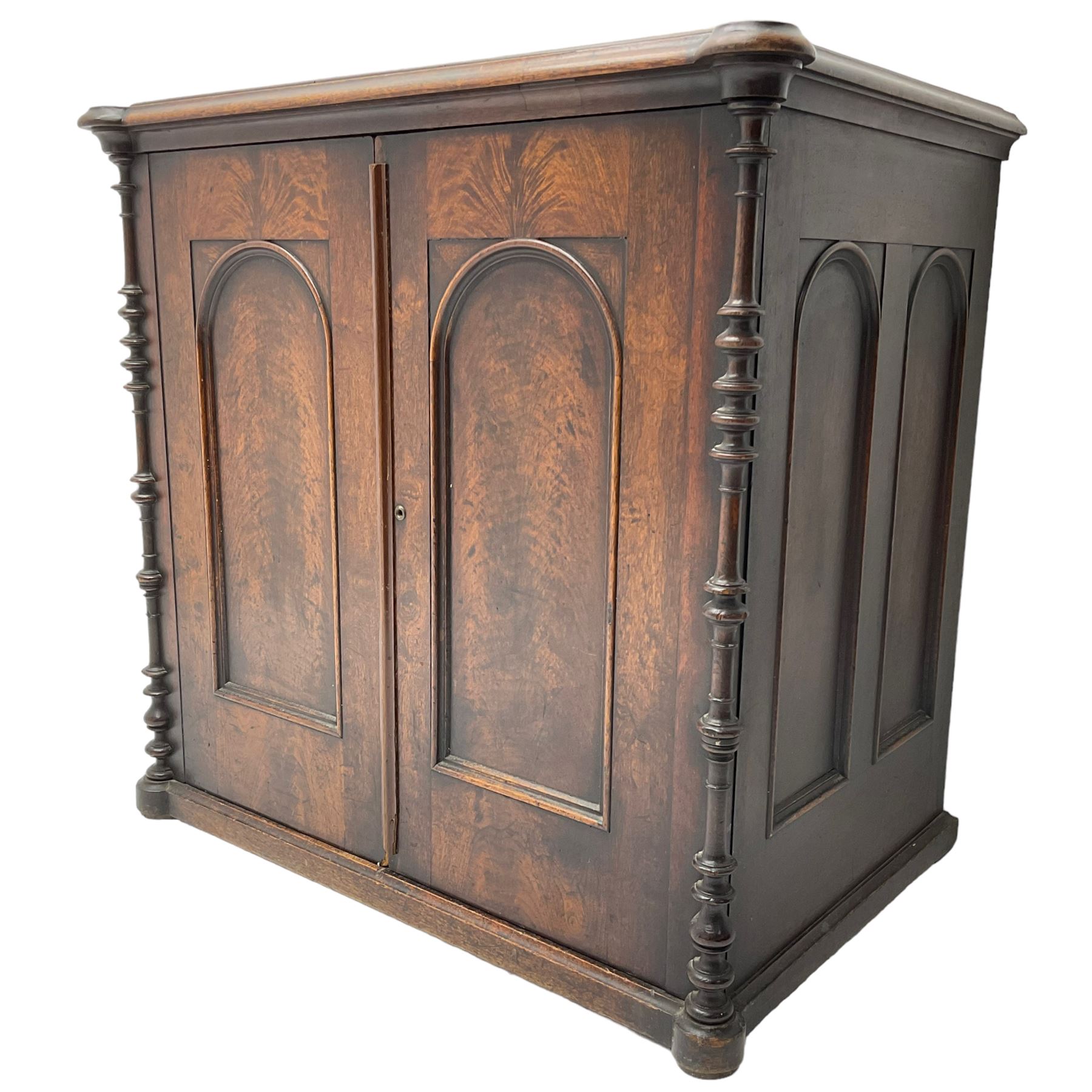 Victorian lacquered mahogany cupboard, fitted with two arch panelled doors enclosing two shelves, flanked by split turned uprights