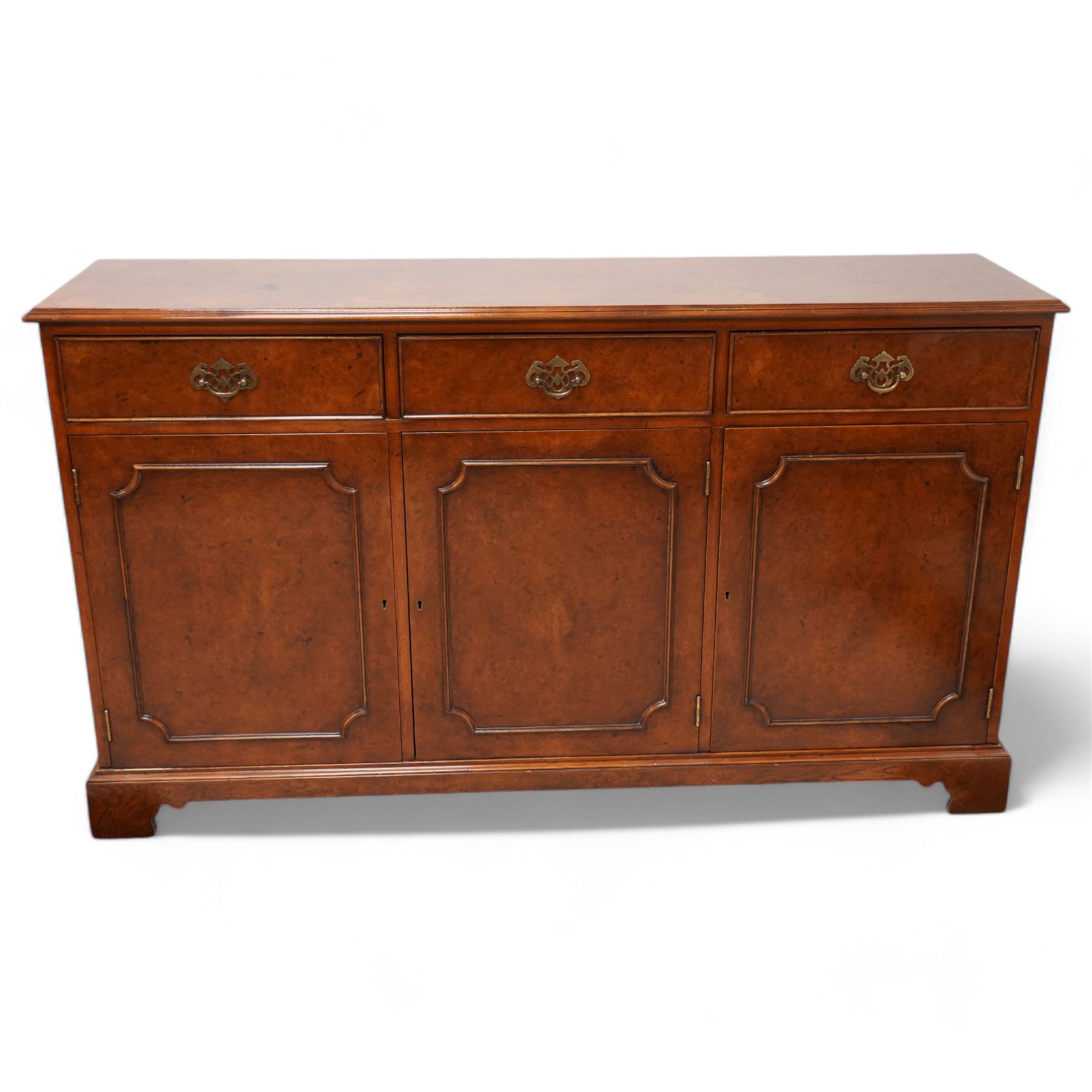 Georgian design figured walnut sideboard, moulded rectangular top over three drawers and three cupboards, on bracket feet 