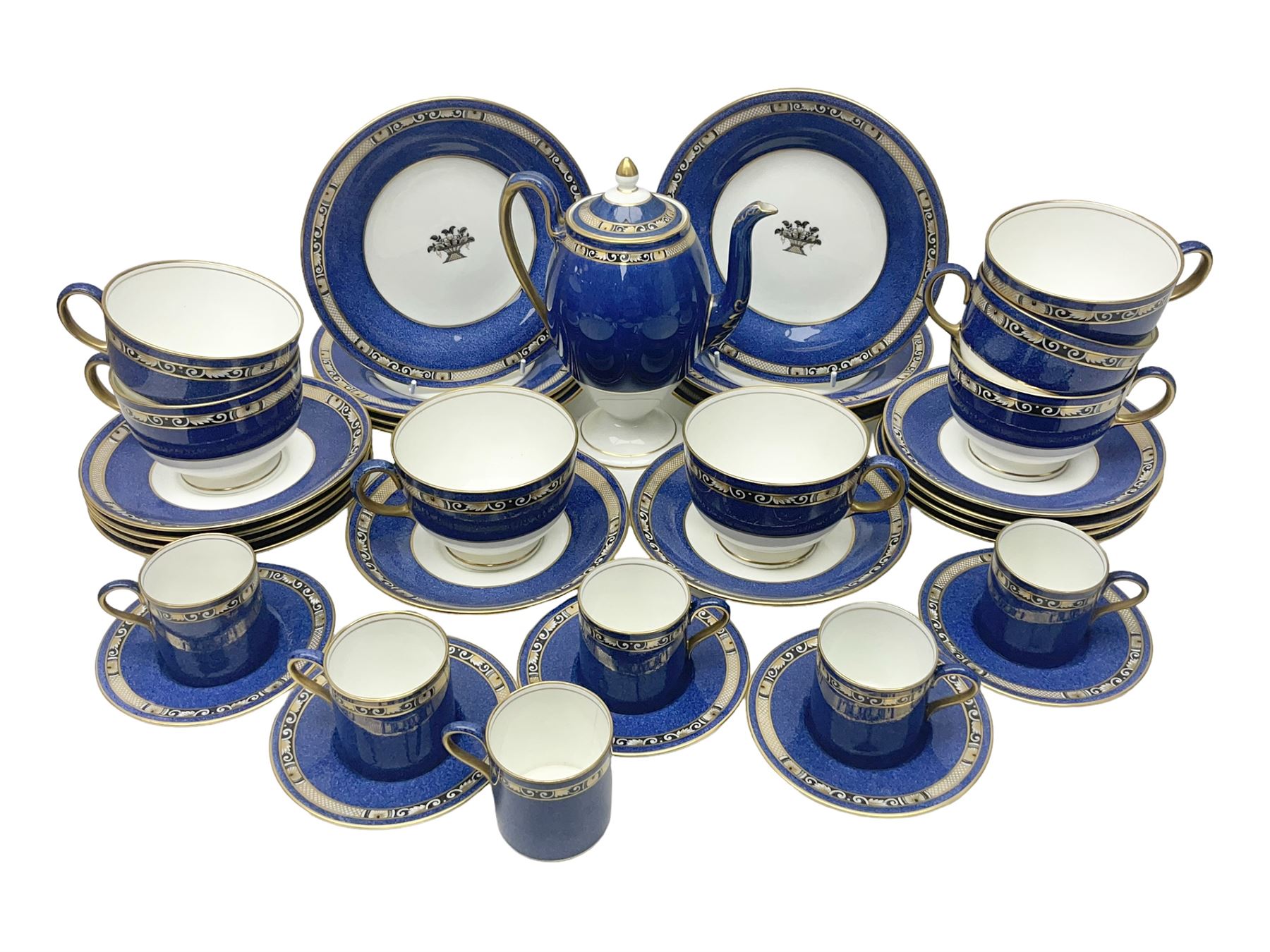 Wedgwood part tea and coffee service, comprising coffee pot, six coffee cans with five saucers, seven teacups with ten saucers and seven side plates, each decorated with floral bouquet to centre, in a gilt and speckled blue border, pattern x9933, with printed mark beneath