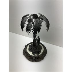 Sculpture of a giraffe under a palm tree upon a mirrored base, H48cm