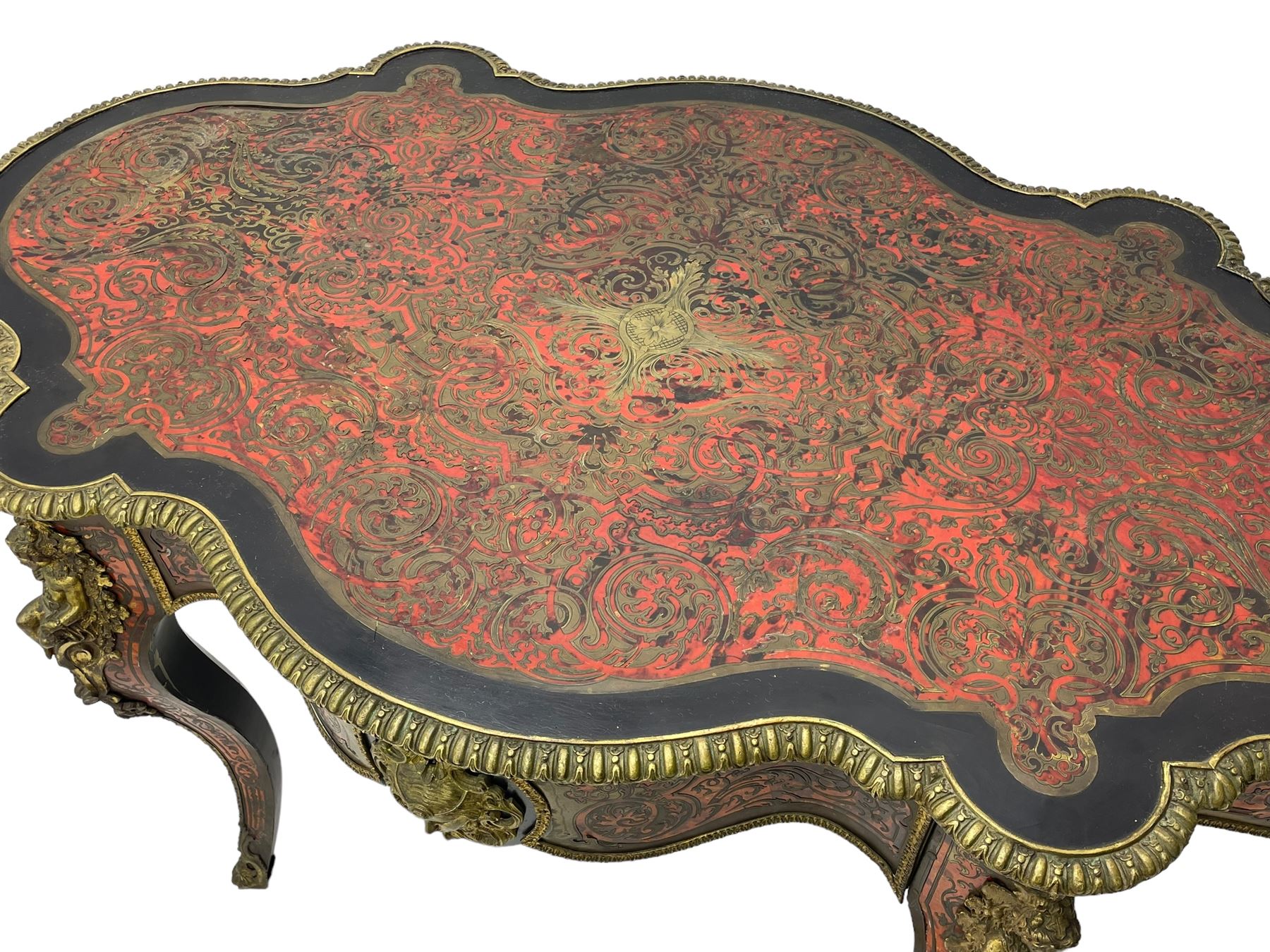 Victorian Louis XV design boulle work centre table, shaped form, decorated extensively with brass and red tortoise shell scroll work, central extending acanthus leaves surrounded by scrolling foliage, gardroon and floral cast brass edge, the frieze rails decorated with further boulle work and green man gilt metal cast masks, the cabriole supports mounted by seated putti mounts on S-scroll brackets surrounded by oak leaves and acorns, ornate scroll and floral cast terminal caps