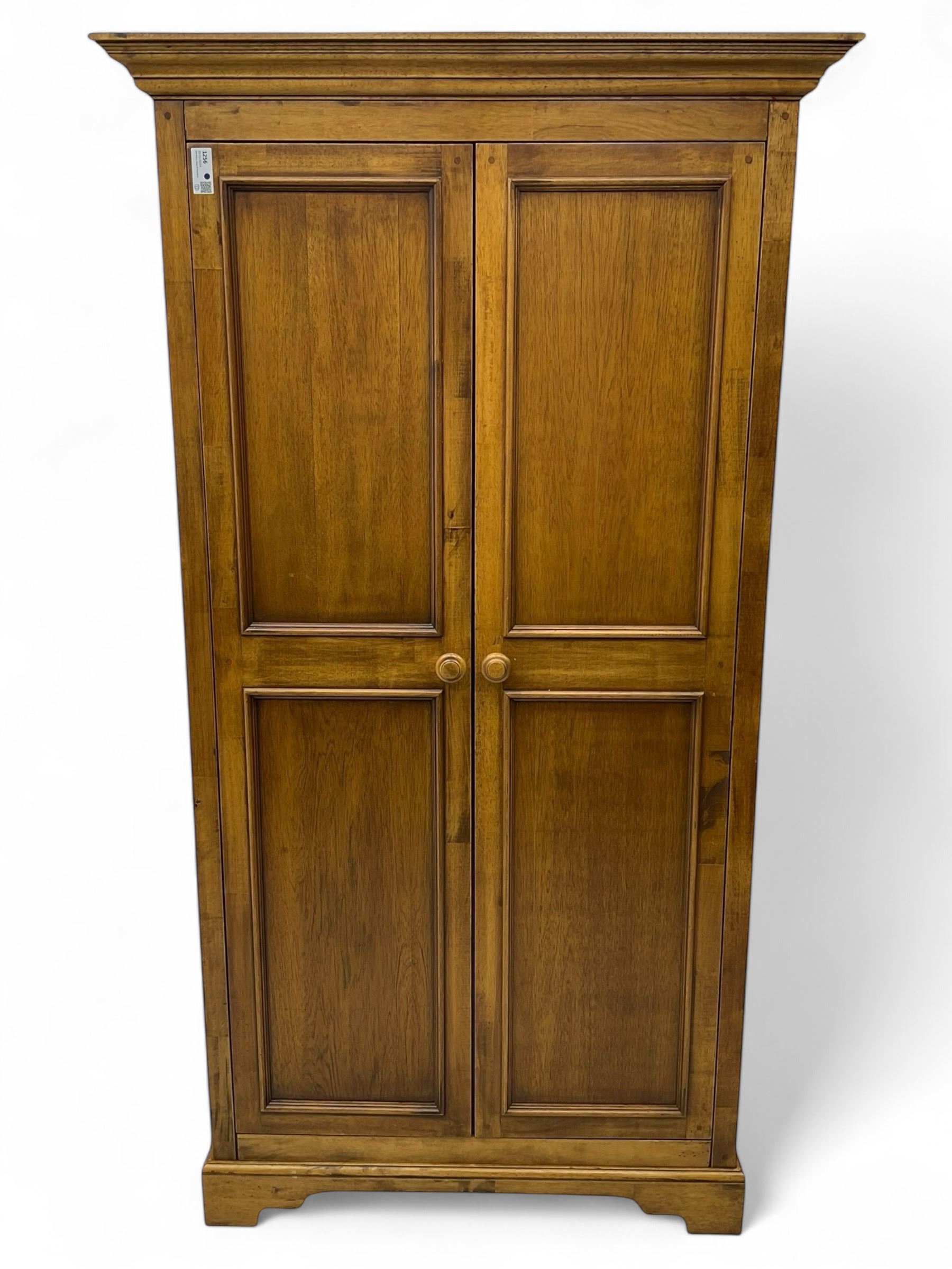 Hardwood double wardrobe, enclosed by two panelled doors, on bracket feet 