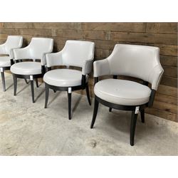 Four ebonised framed tub shaped armchairs, upholstered in grey fabric