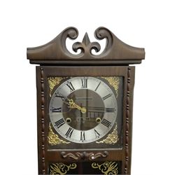 Month going twin train spring driven wall clock - in a glazed oak case with a swan necked pediment, silvered chapter ring with Roman numerals and gilt hands, with cast brass spandrels and a visible pendulum, striking movement, sounding the hours and half hours on a gong.