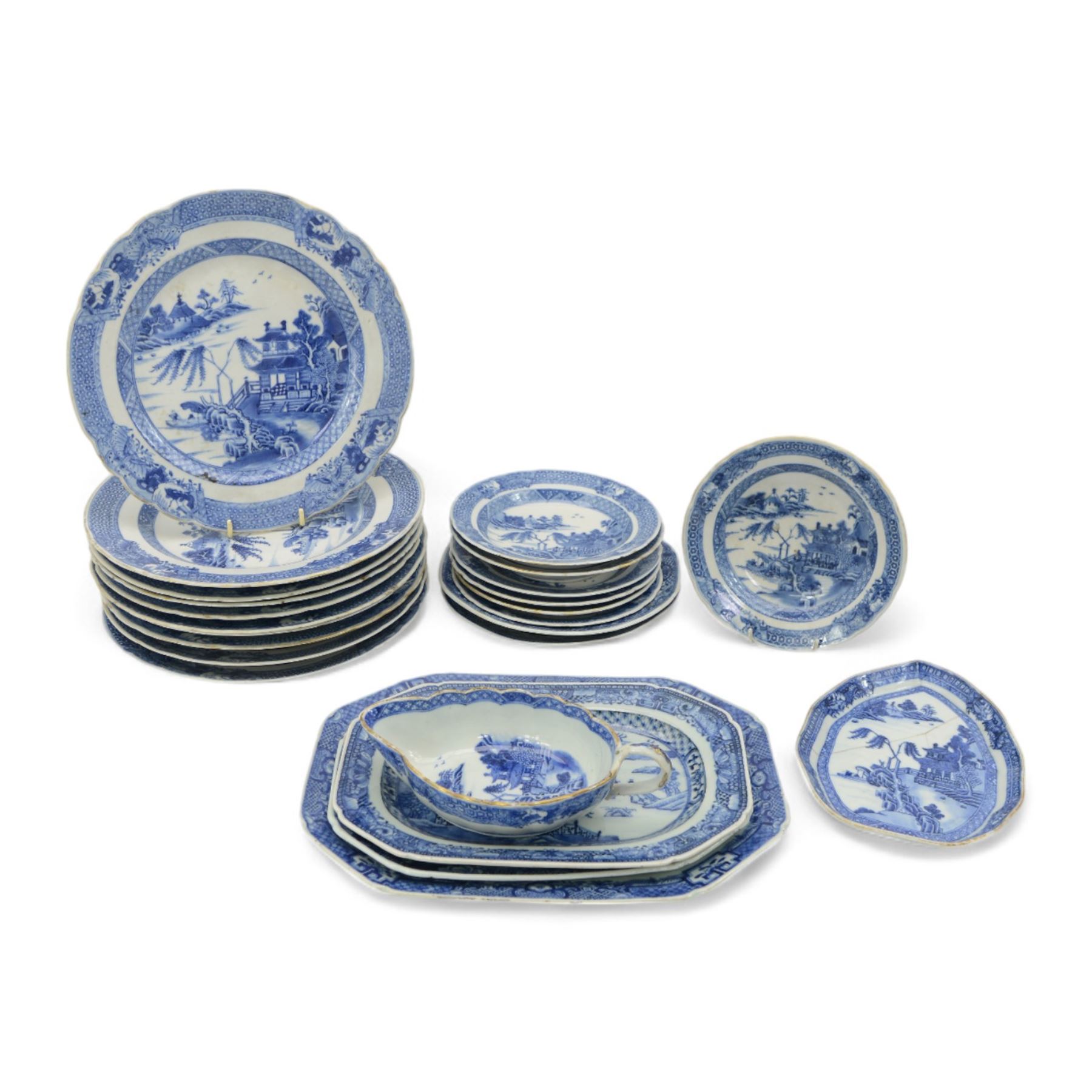 18th century Chinese Export blue and white part dinner service, comprising four soup bowls, four tea plates, sauceboat and stand, five dinner plates, D24cm, five bowls and a smaller plate, each decorated with pagodas and figures in a landscape, within foliate and cell borders, together with three matching 18th century Chinese Export rectangular platters, max L29cm (24)