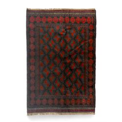 Baluchi indigo ground rug, the field decorated with all-over crimson and indigo lozenges, ...