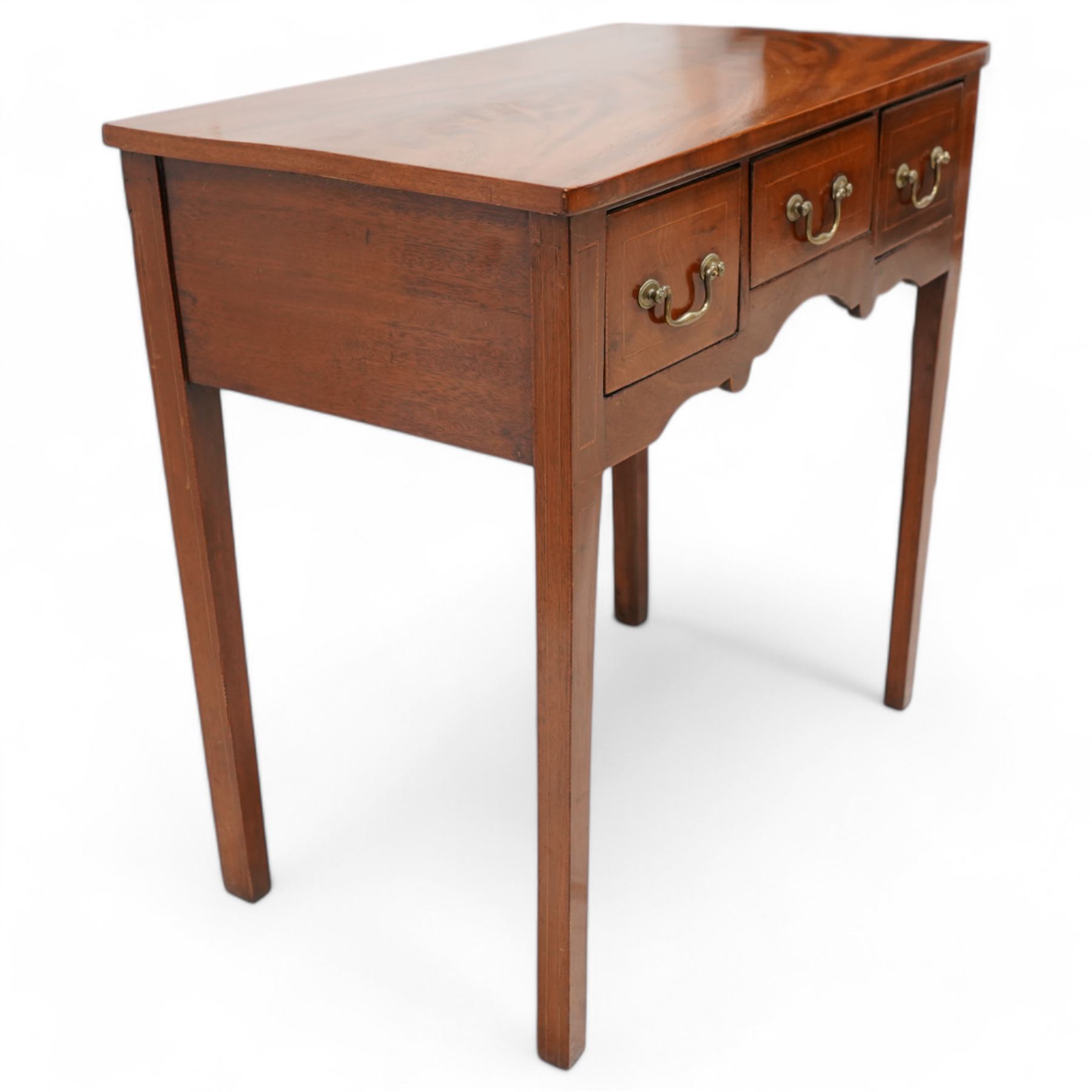 George III inlaid mahogany low-boy, shaped rectangular top with banded edge, fitted with three drawers inlaid with boxwood stringing over a shaped apron, raised on square supports with inner chamfer