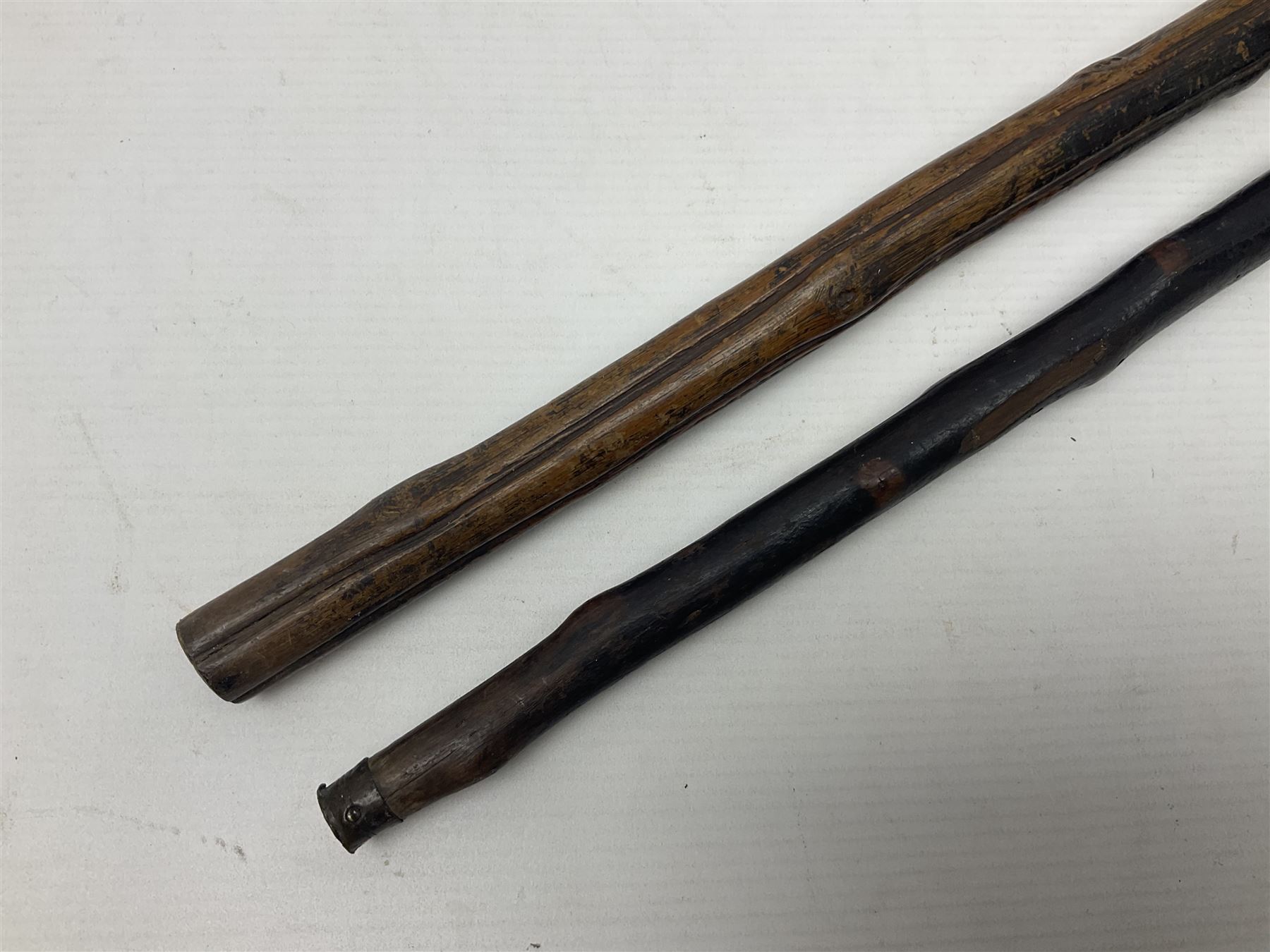 Two wooden walking sticks, both with comparts that would have housed horse measures, H88cm