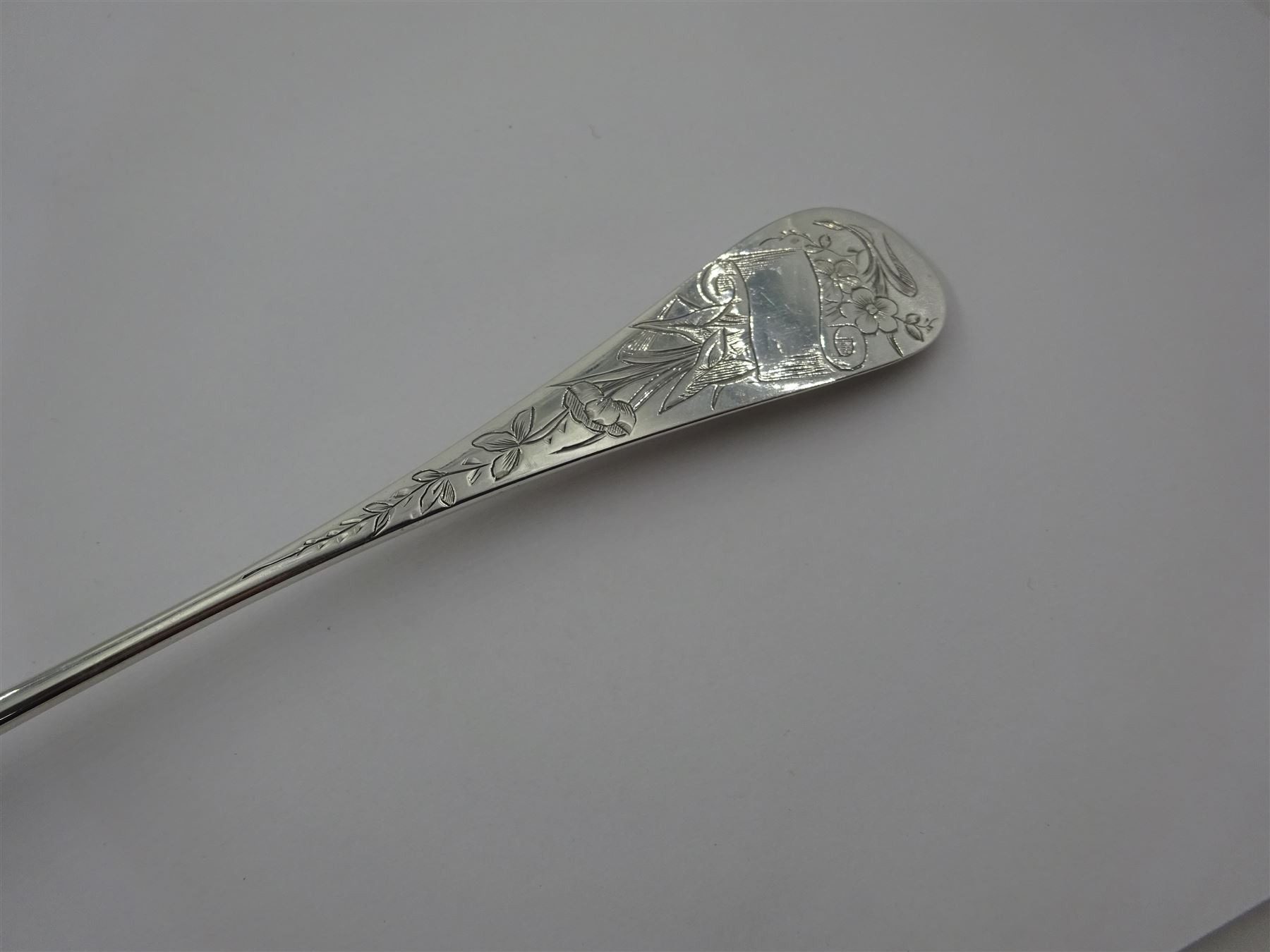 French silver aesthetic movement serving spoon, the scallop edged bowl engraved with a bird amongst flowers and foliage, stamped with Minerva's head standard and weevil export mark, L23cm