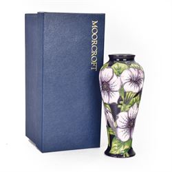 Moorcroft vase in Petunia pattern upon a purple ground, of tall baluster form, marked made for collectables to the base,  with original box, H21cm