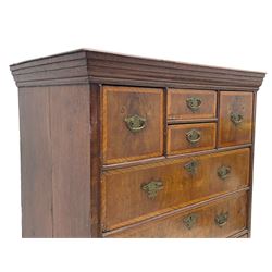 18th century oak and walnut chest, fitted with four small over three long drawers with figured walnut facias, brass handles and plates with engraved decoration, on bracket feet