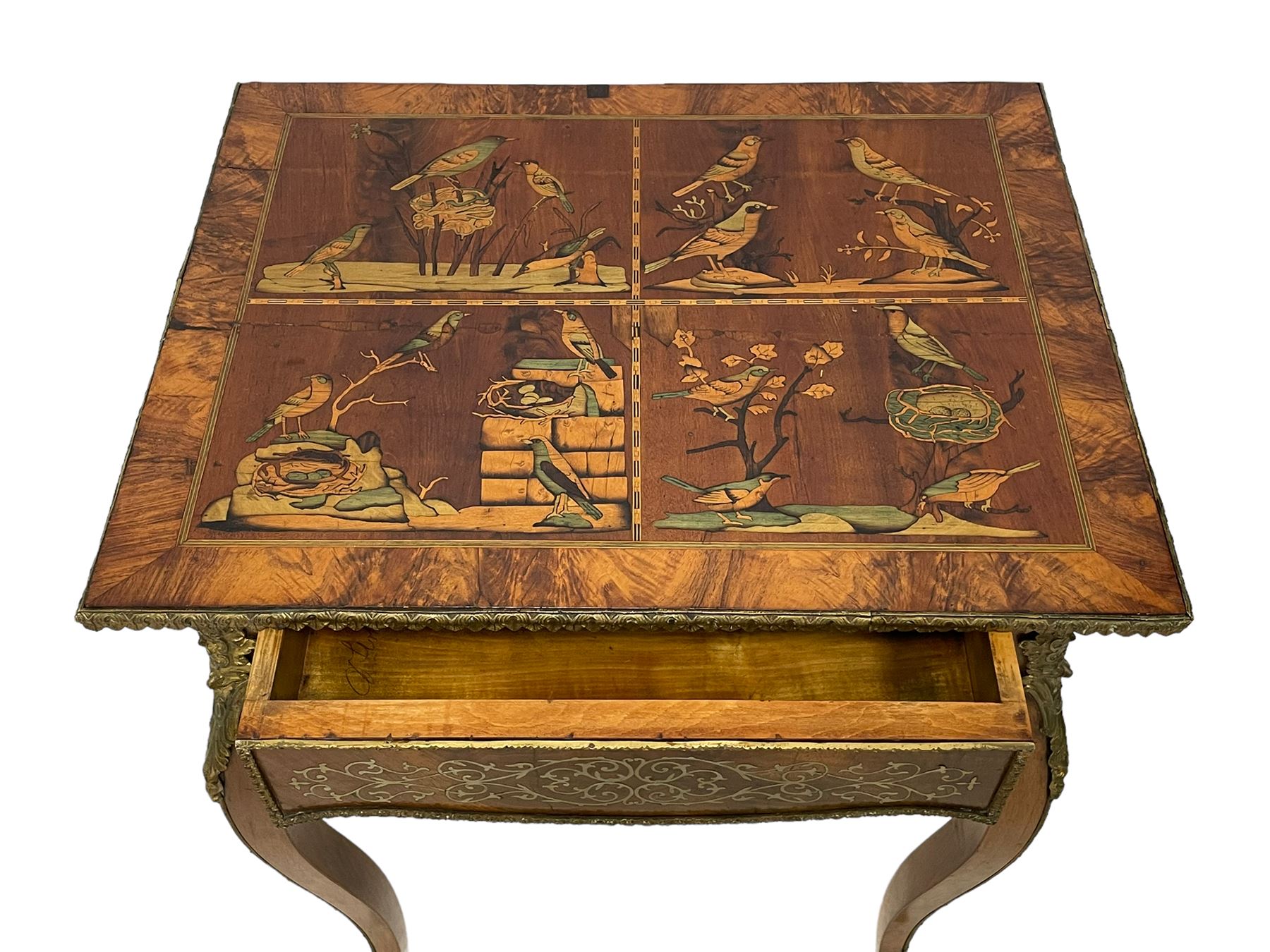 In the manner of Émile Gallé - late 19th to early 20th century inlaid walnut side table, rectangular top inlaid with Japonisme decoration depicting birds within trees, figured crossbanding and cast gilt foliate applied edge, single frieze drawer inlaid with scrolling brass work, on cabriole supports with ornate floral mounts